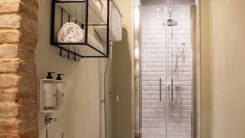 A bathroom with a shower, a toilet, and a bidet.
