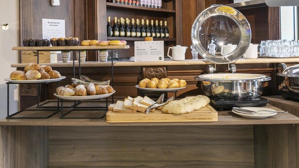 A breakfast buffet with pastries, bread, and a coffee station. - B&B Hotel Pomezia Cortese (Pomezia)