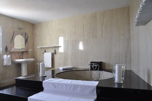 A modern bathroom with a sink, mirror, and shower. - Hotel Mamabels (Mojacar)