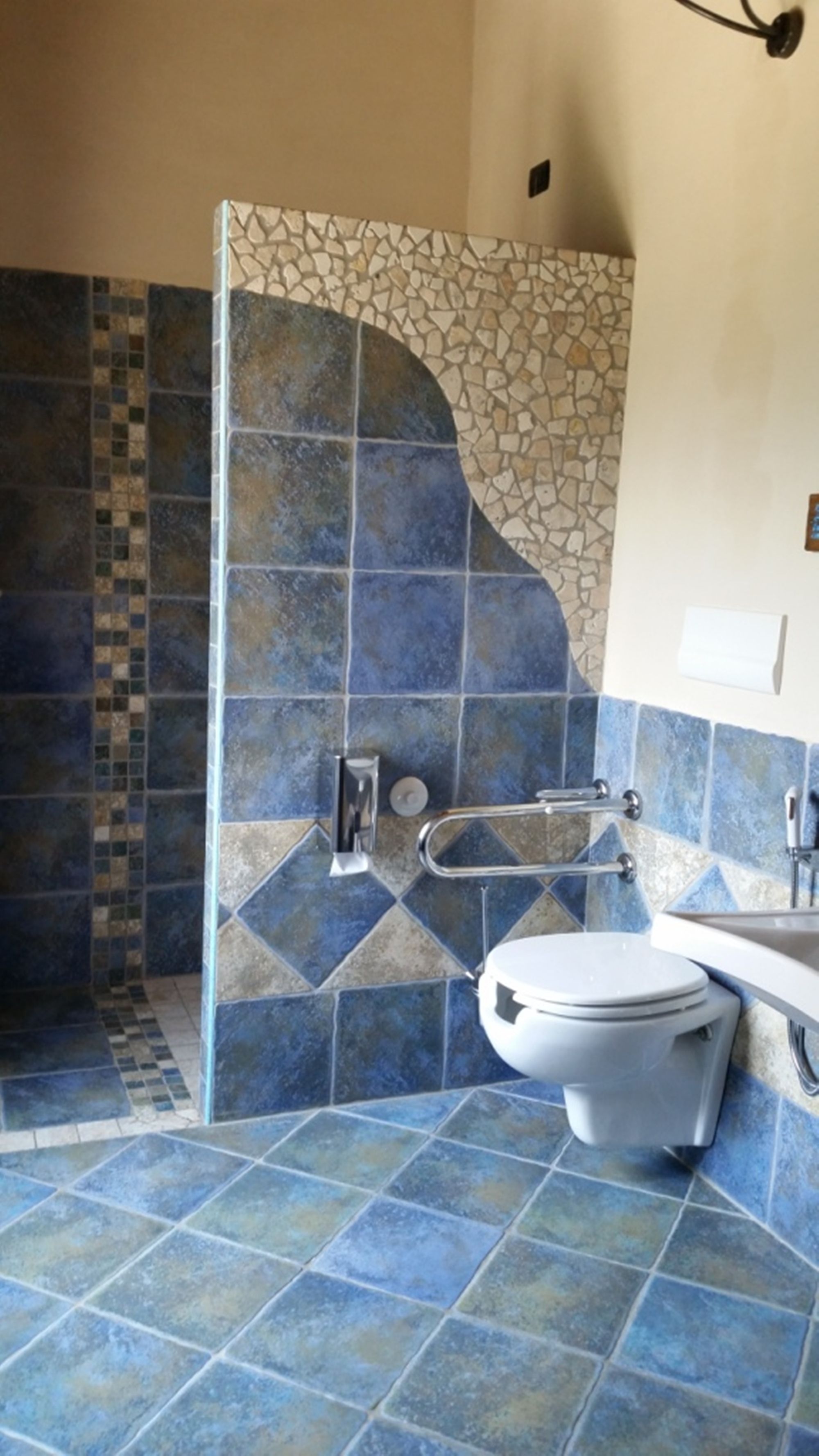 A bathroom with a shower, toilet, and sink.