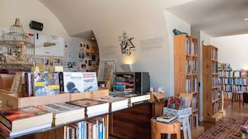 A cozy bookstore with wooden shelves and a variety of books.