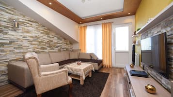 Exclusive Apartment, 2 Bedrooms, Sea View | Living area | 54-cm flat-screen TV with cable channels, TV, video-game console