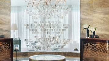 Experience the grandeur of our lobby, featuring a stunning crystal chandelier and serene water feature.