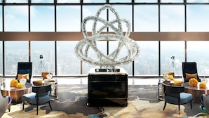A modern hotel room with a large window, a unique abstract sculpture, and a city view. - The St. Regis Shenzhen (Shenzhen)
