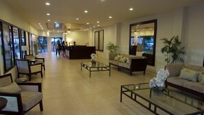 A spacious lobby with a reception desk, seating area, and large windows. - Subic Grand Seas Resort (Olongapo)