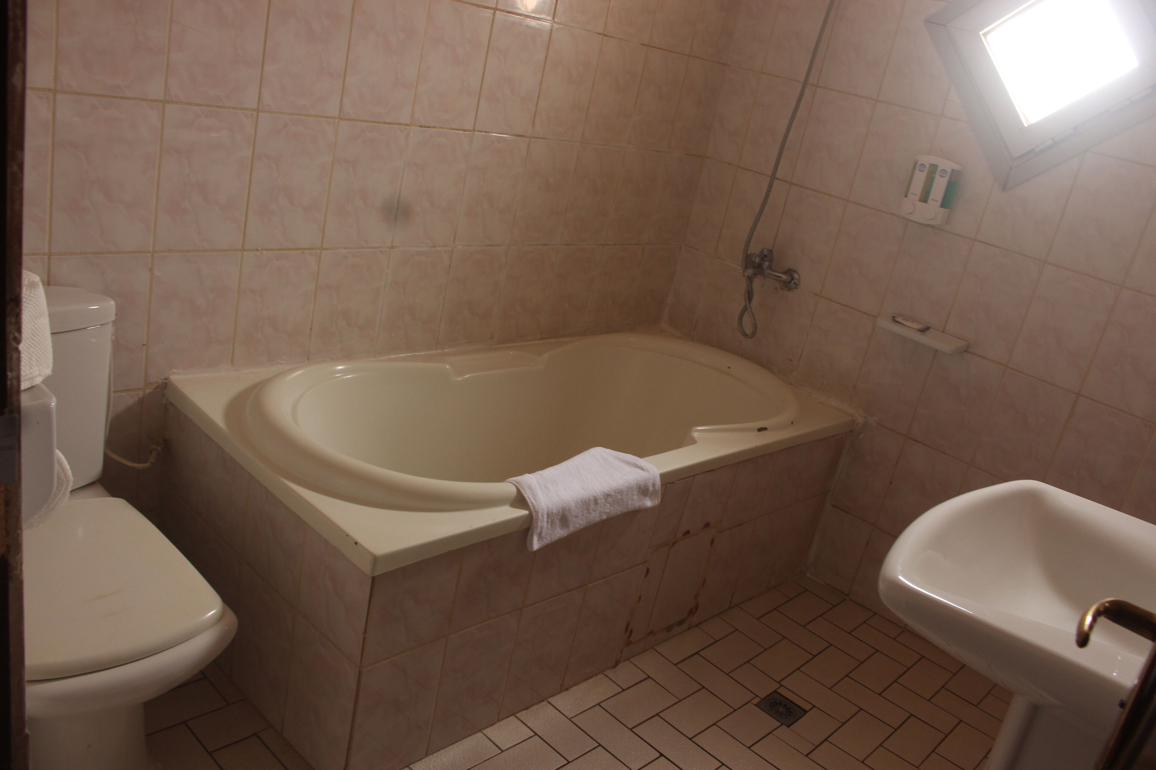 A bathroom with a bathtub, toilet, and sink.