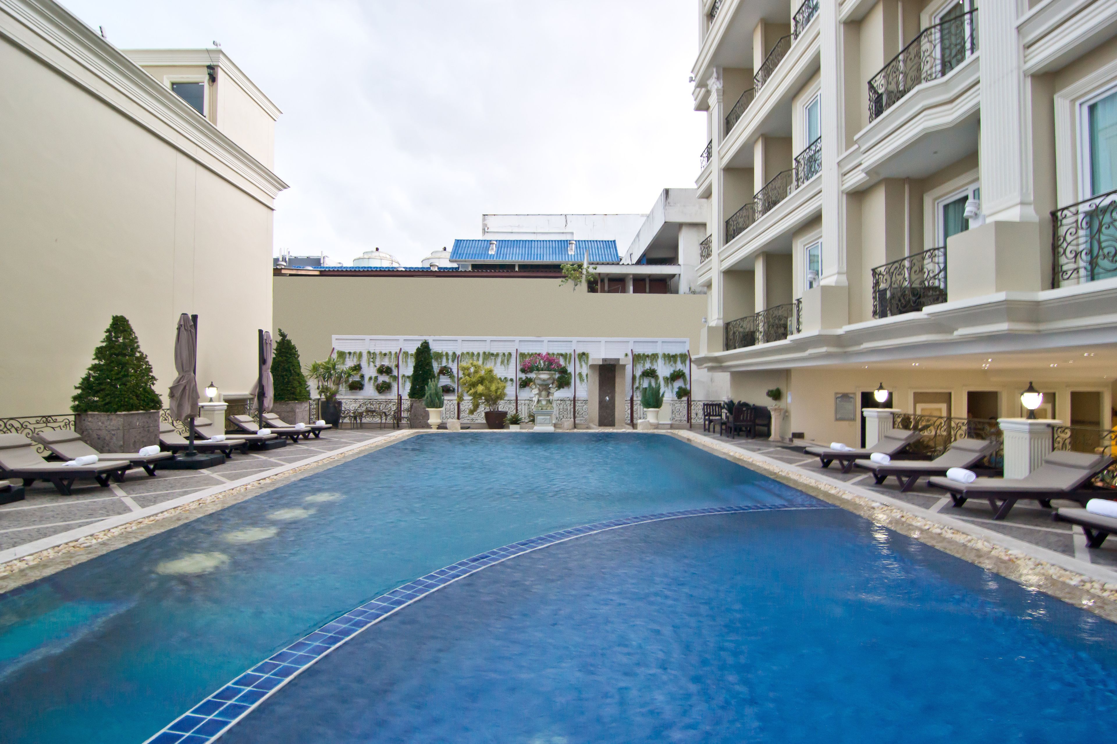 Outdoor pool, open 7 AM to 7 PM, pool umbrellas, pool loungers