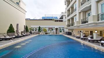 Outdoor pool, open 7 AM to 7 PM, pool umbrellas, pool loungers