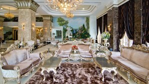 A luxurious lobby with ornate furniture, a grand chandelier, and a mural on the wall. - LK The Empress Pattaya (Pattaya)
