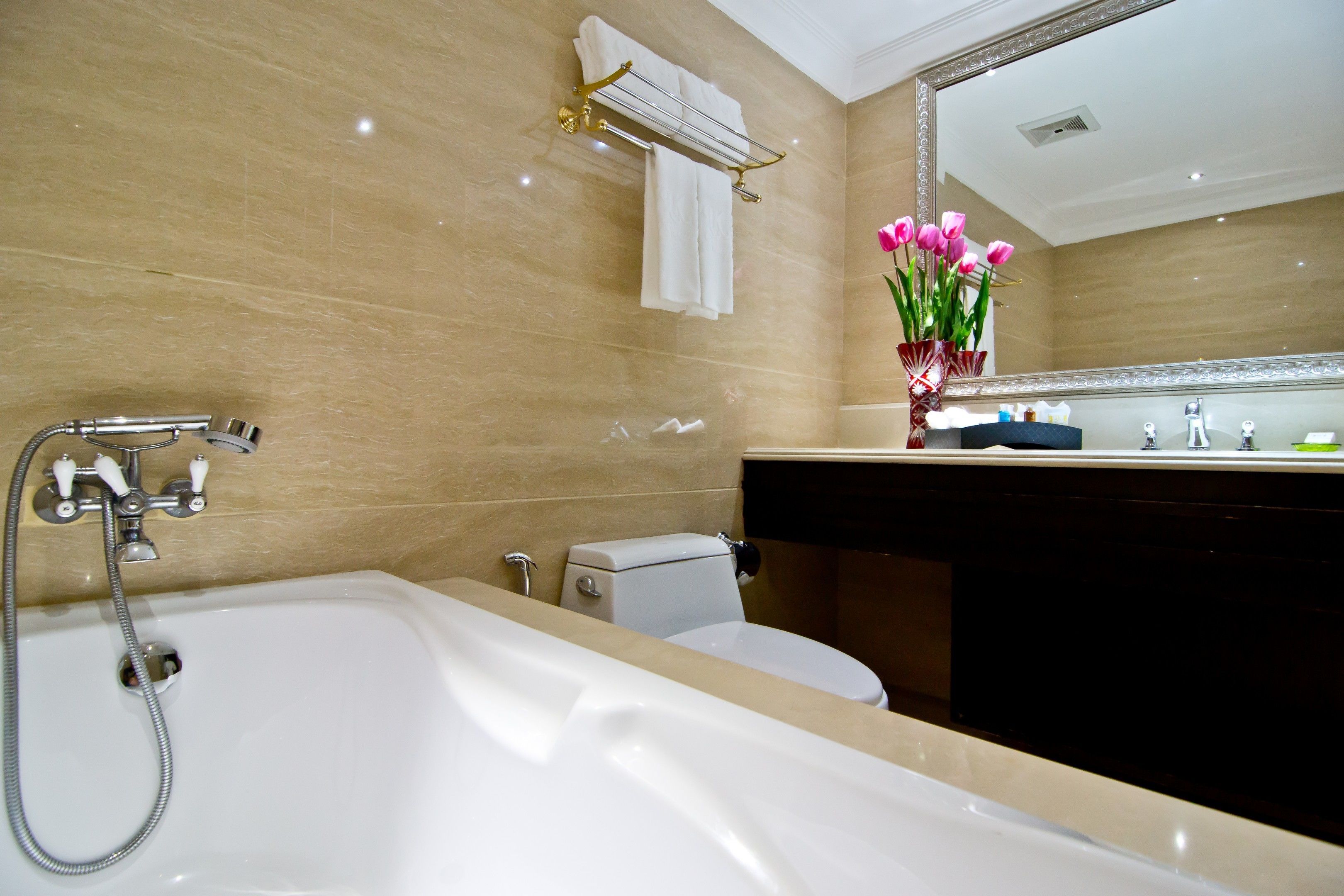 A bathroom with a bathtub, toilet, and sink.