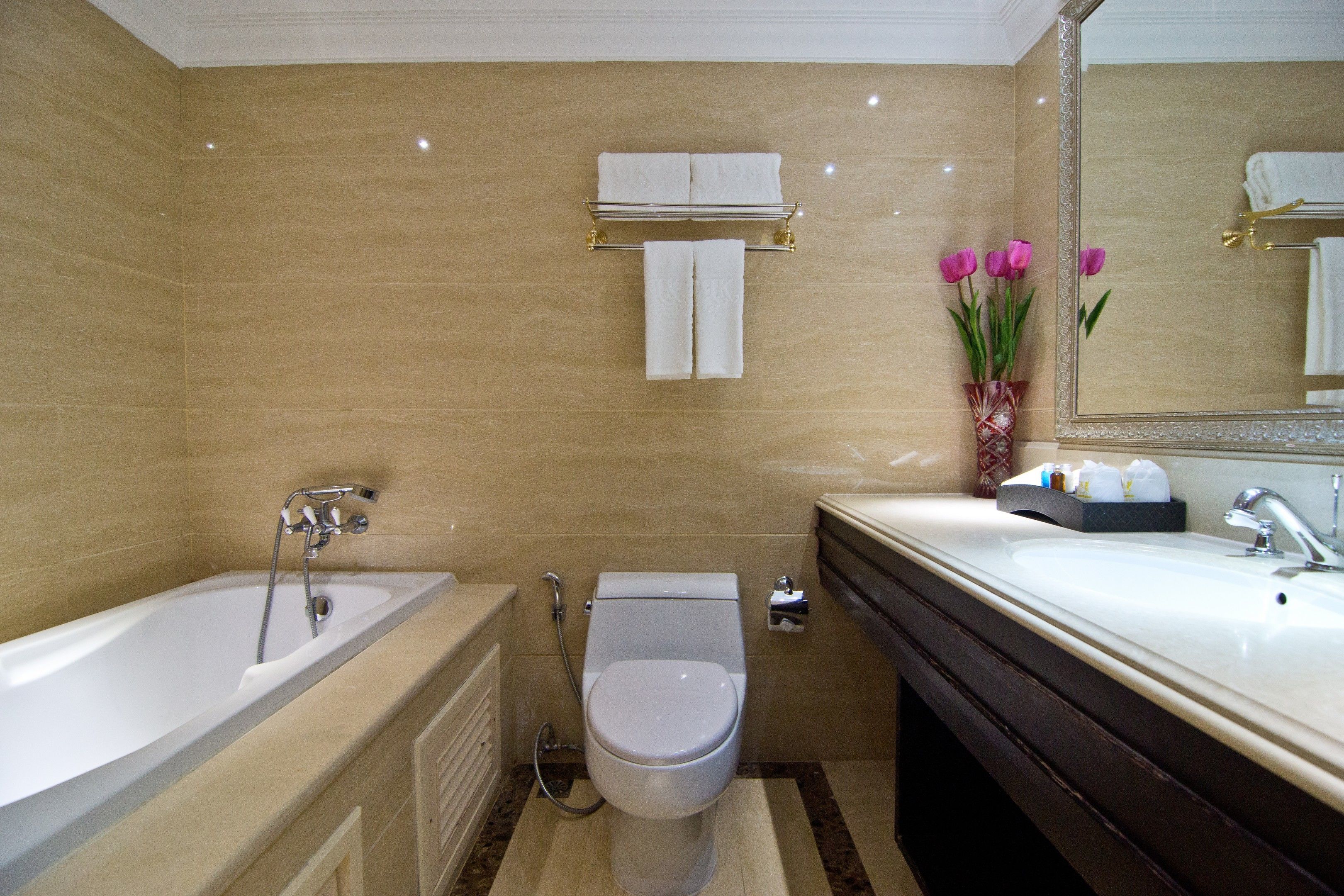 A modern bathroom with a bathtub, toilet, and sink.