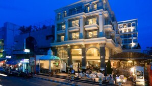 A multi-story hotel with a grand entrance, outdoor seating area, and a well-lit facade. - LK The Empress Pattaya (Pattaya)