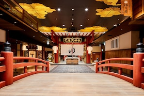A traditional Japanese interior with a wooden bridge leading to a central altar. - Hotel MyStays Sakaisuji Honmachi (Osaka)