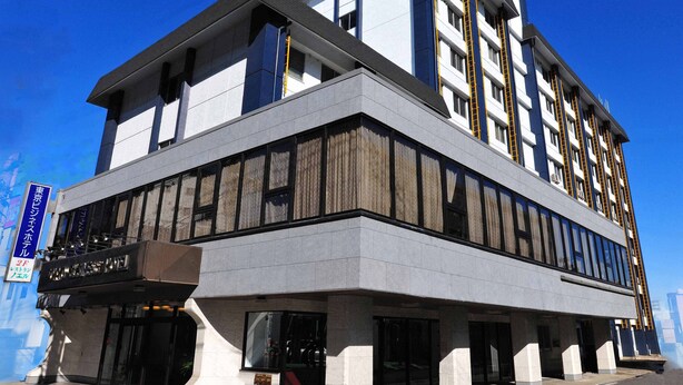 A modern hotel with a two-story structure, large windows, and a prominent entrance with a red carpet. - Tokyo Business Hotel (Tokyo)