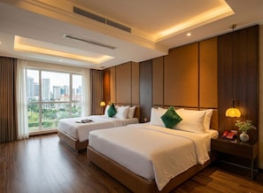 A hotel room with two beds, a city view, a telephone, and a vase on the nightstand. - Bon Ami Hotel - Thiên Xuân (Ho Chi Minh City)