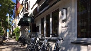 Ein Gebäude mit einem Schild, auf dem "Famie Hotels" steht, und mehreren Fahrrädern, die davor abgestellt sind.