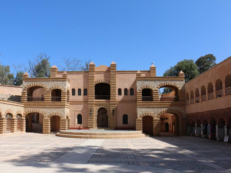 A historic building with multiple arches and a central courtyard.