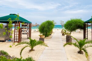 On the beach, sun loungers, beach umbrellas, beach towels