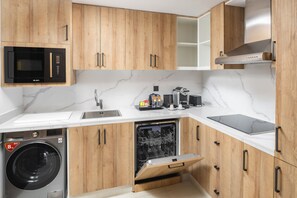 Fully equipped kitchen with appliances, sink, and countertop space.