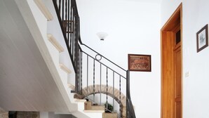A staircase with a stone wall on one side and a wooden door at the top. - Il Castello (Assisi)