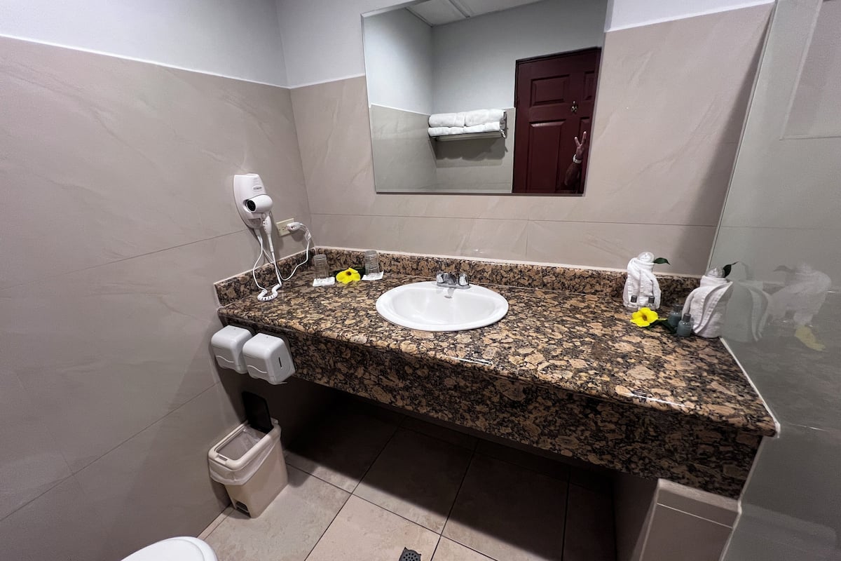 shower, rainfall showerhead, hair dryer, towels