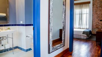 A bathroom with a sink, mirror, and toilet.