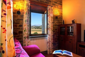 A room with a window, a radiator, a wooden cabinet, and a book on a table.