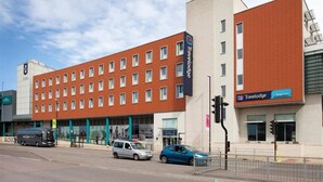 A Travelodge hotel with a red brick facade, multiple windows, and a signboard. - Travelodge Gloucester (Gloucester)
