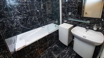 A bathroom with a bathtub, a sink, and a toilet.