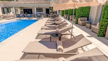 Piscine extérieure, parasols de plage, chaises longues