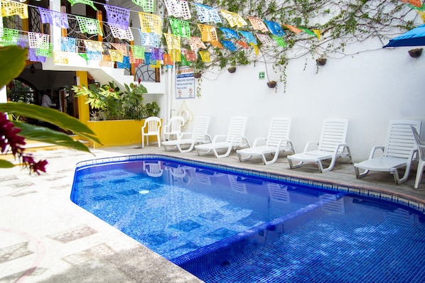 Outdoor pool, open 9:00 AM to 9:00 PM, pool umbrellas, pool loungers