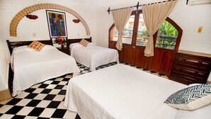 A hotel room with three beds, checkered floor, arched window, and a painting on the wall. - Hotel Hacienda de Vallarta Centro (Puerto Vallarta)