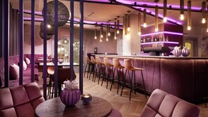 A modern bar area with purple lighting, cushioned seating, and a bar counter with stools. - Adler Inn Tyrol Mountain Resort SUPERIOR (Tux)