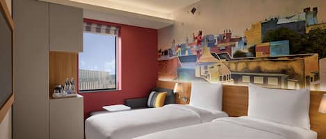 A hotel room with two beds, a red accent wall, a large window, and a mural of a cityscape.