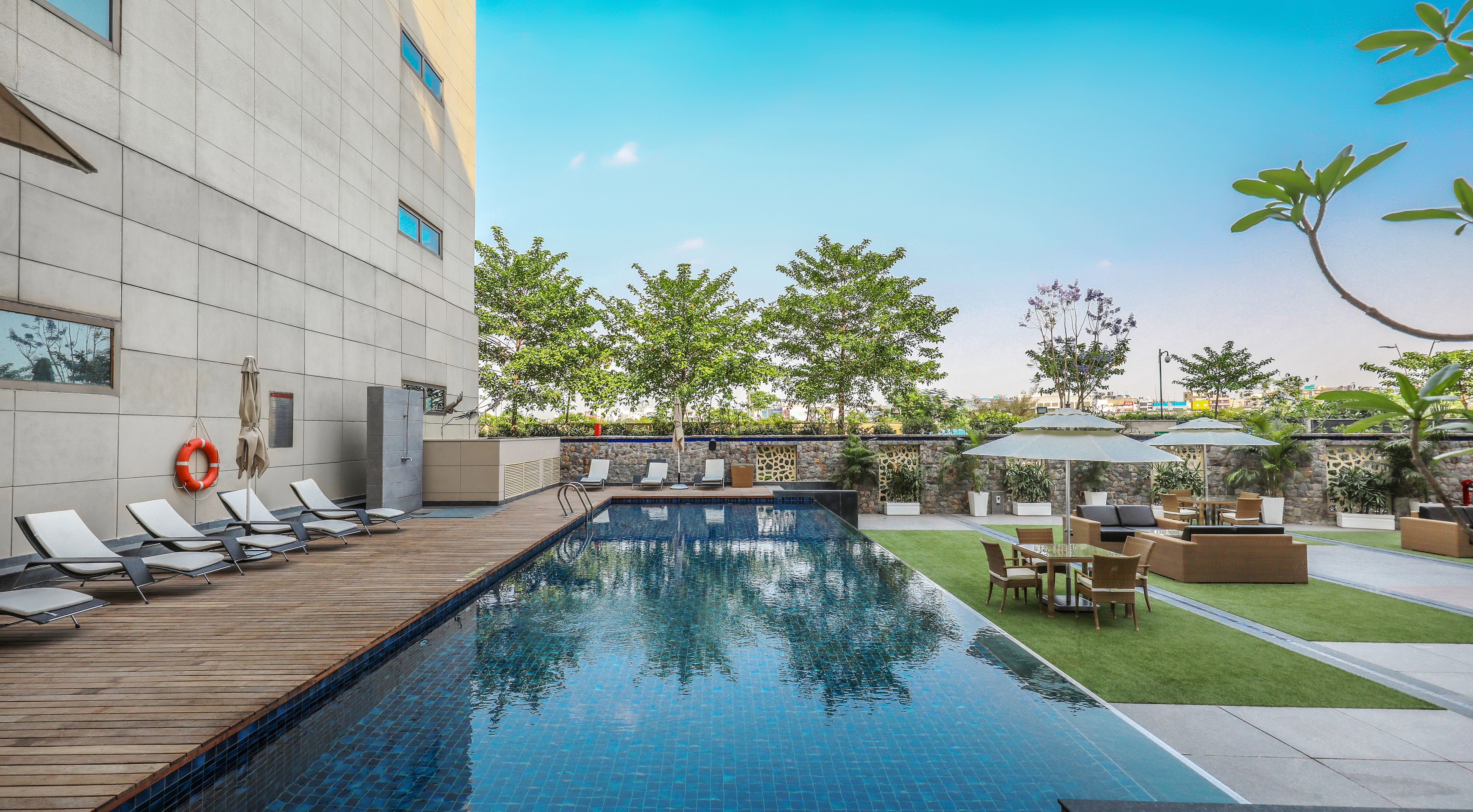 outdoor pool, open 9:00 am to 8:00 pm, pool umbrellas, pool loungers