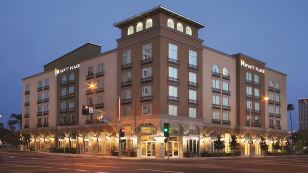 A multi-story hotel with a flat roof, large windows, and a sign reading "Hyatt Place".