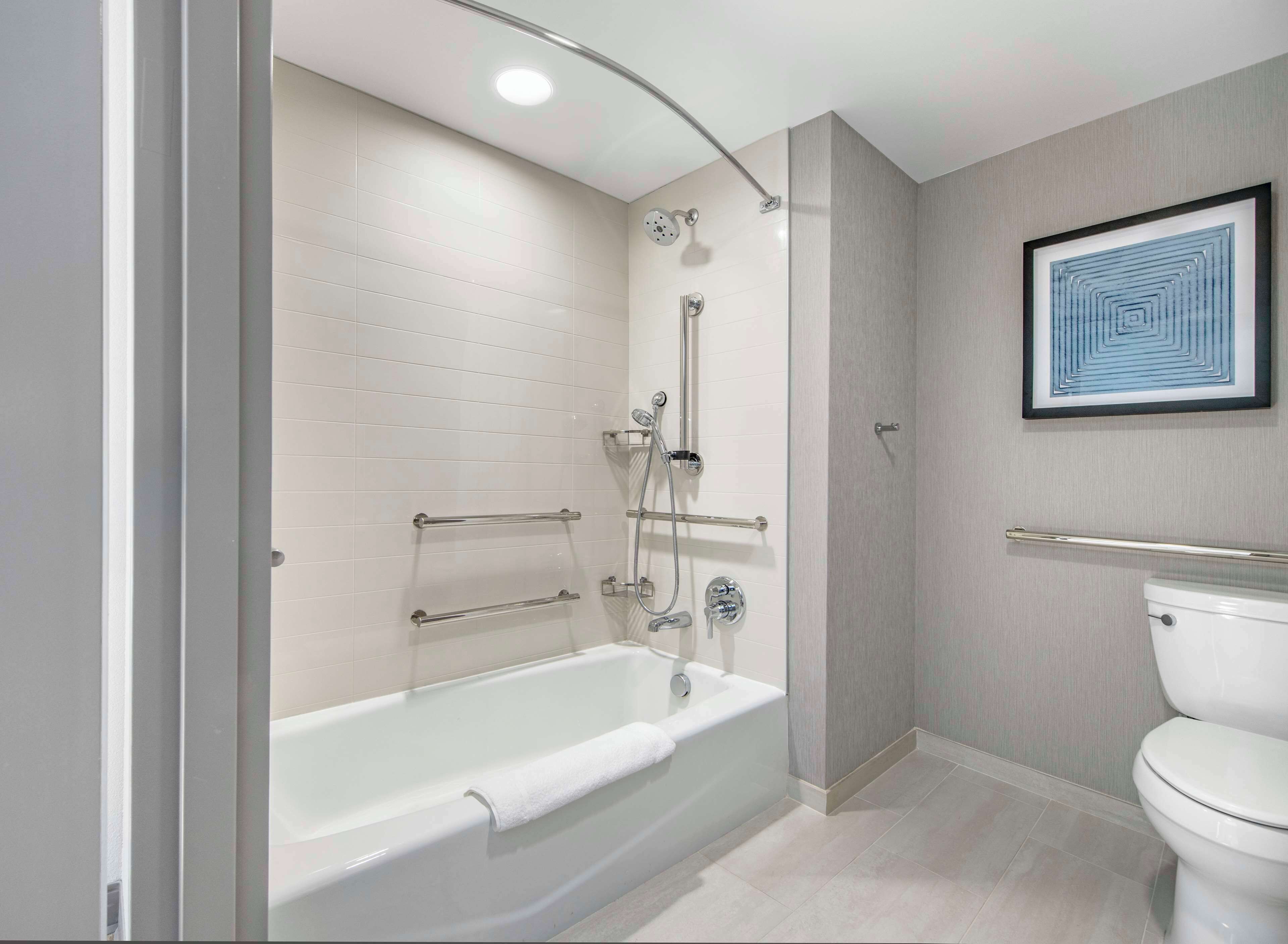 combined shower/bathtub, designer toiletries, hair dryer, towels