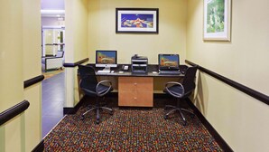 A hotel office area with two desks, chairs, a filing cabinet, and framed artwork on the walls. - La Quinta Inn & Suites by Wyndham Tulsa - Catoosa Route 66 (Catoosa)