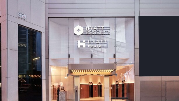 The exterior of a Hyatt Emergency House with a modern design, featuring a glass entrance and a sign above the doors. - Hyatt Regency London Stratford (London)