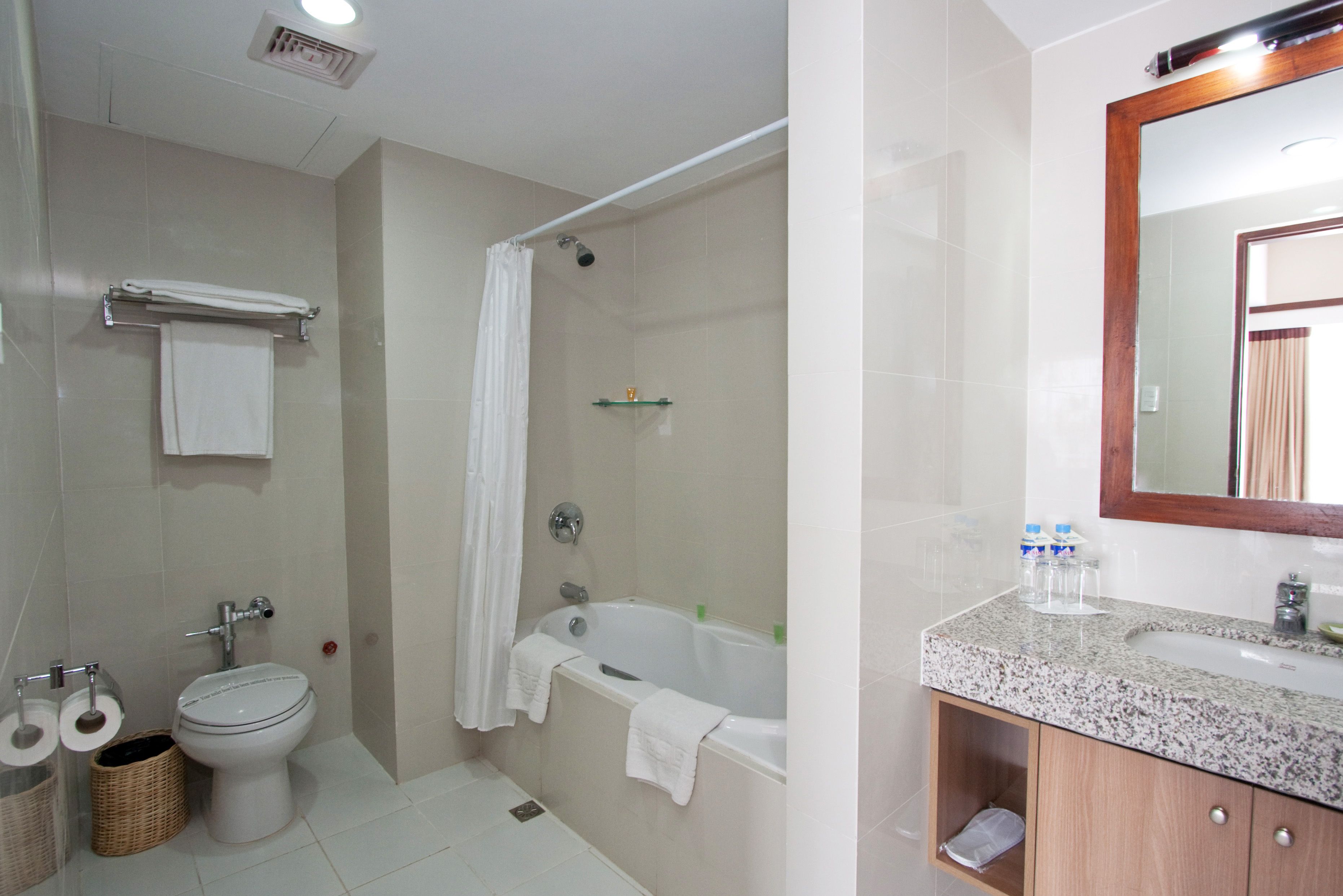 A bathroom with a toilet, sink, and bathtub.