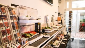 A buffet setup with various food items and condiments. - Hotel Prens Berlin (Berlin)