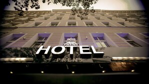 A hotel facade with a prominent "HOTEL" sign, multiple windows, and a balcony area. - Hotel Prens Berlin (Berlin)