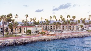 A resort with multiple-story buildings, a pool area, and a rocky shoreline. - Estero Beach Hotel & Resort (Ensenada)