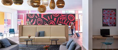 A modern living room with a sofa, coffee table, and decorative lamps.