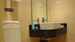 A bathroom with a toilet, a sink, and a mirror. - Ane Hotel - Xinhong Branch (Chengdu)