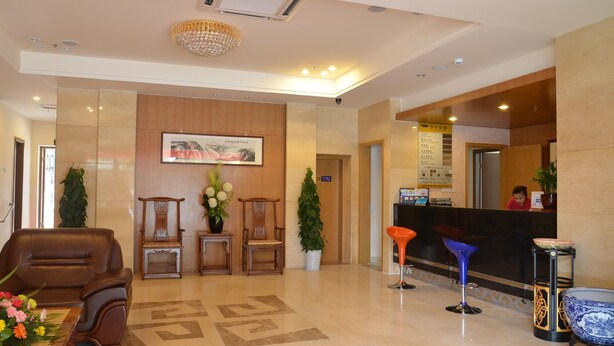 A hotel lobby with a reception desk, seating area, and a large chandelier. - Ane Hotel - Xinhong Branch (Chengdu)