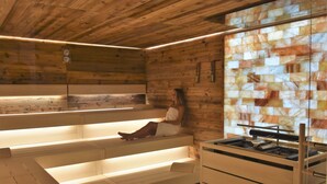 Un sauna avec des murs en bois, un banc et une table de sauna.