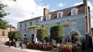 A traditional hotel with a sign reading "CROUCH & MANS HOTEL" and "YOUNGS" on the side.