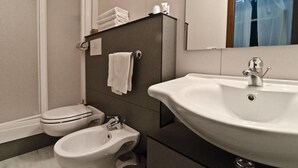 A modern bathroom with a toilet, bidet, and a large sink. - Via Palazzo Sanremo (Sanremo)