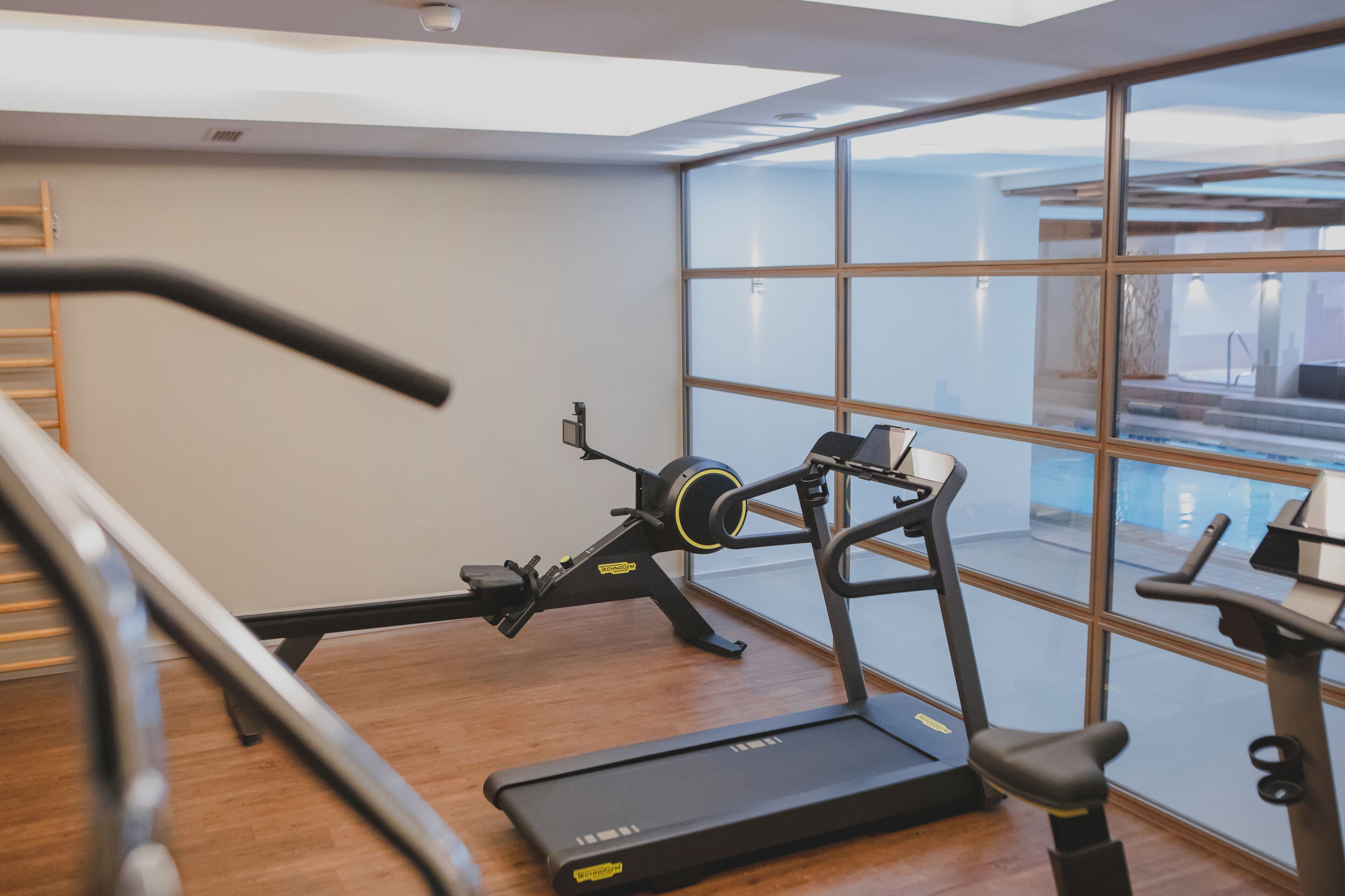 A gym with cardio equipment, a treadmill, and a stationary bike.